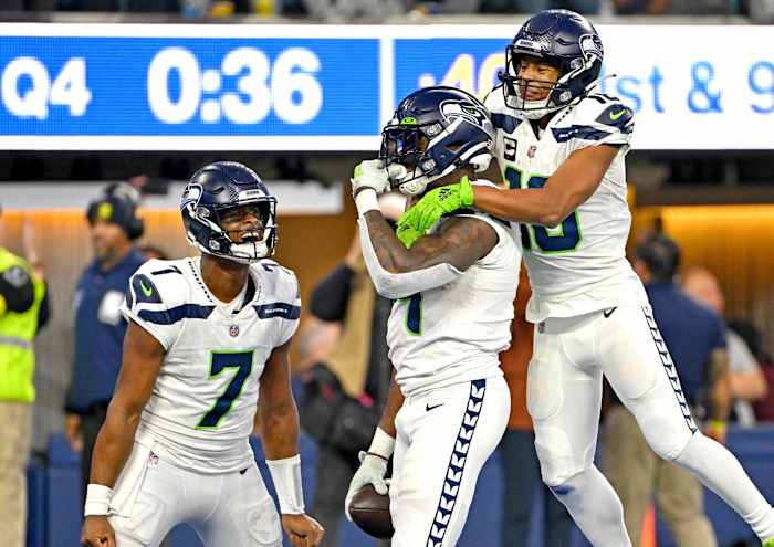 Seattle's Geno Smith, DK Metcalf and Tyler Lockett celebrate after Metcalf's eight-yard touchdown gave the Seahawks a 27-23 win over the Rams in Week 13.